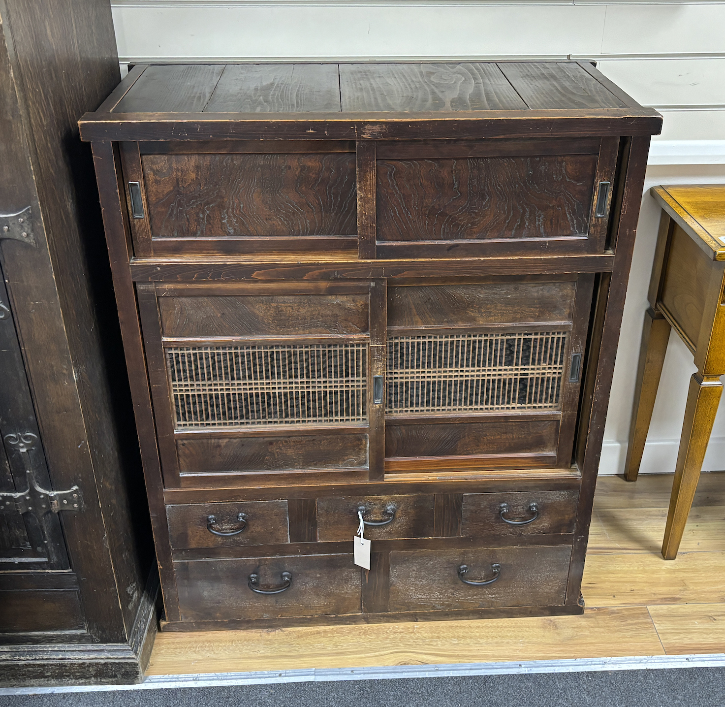 A Japanese hardwood cabinet, fitted with drawers and sliding panels, width 88cm, depth 42cm, height 104cm